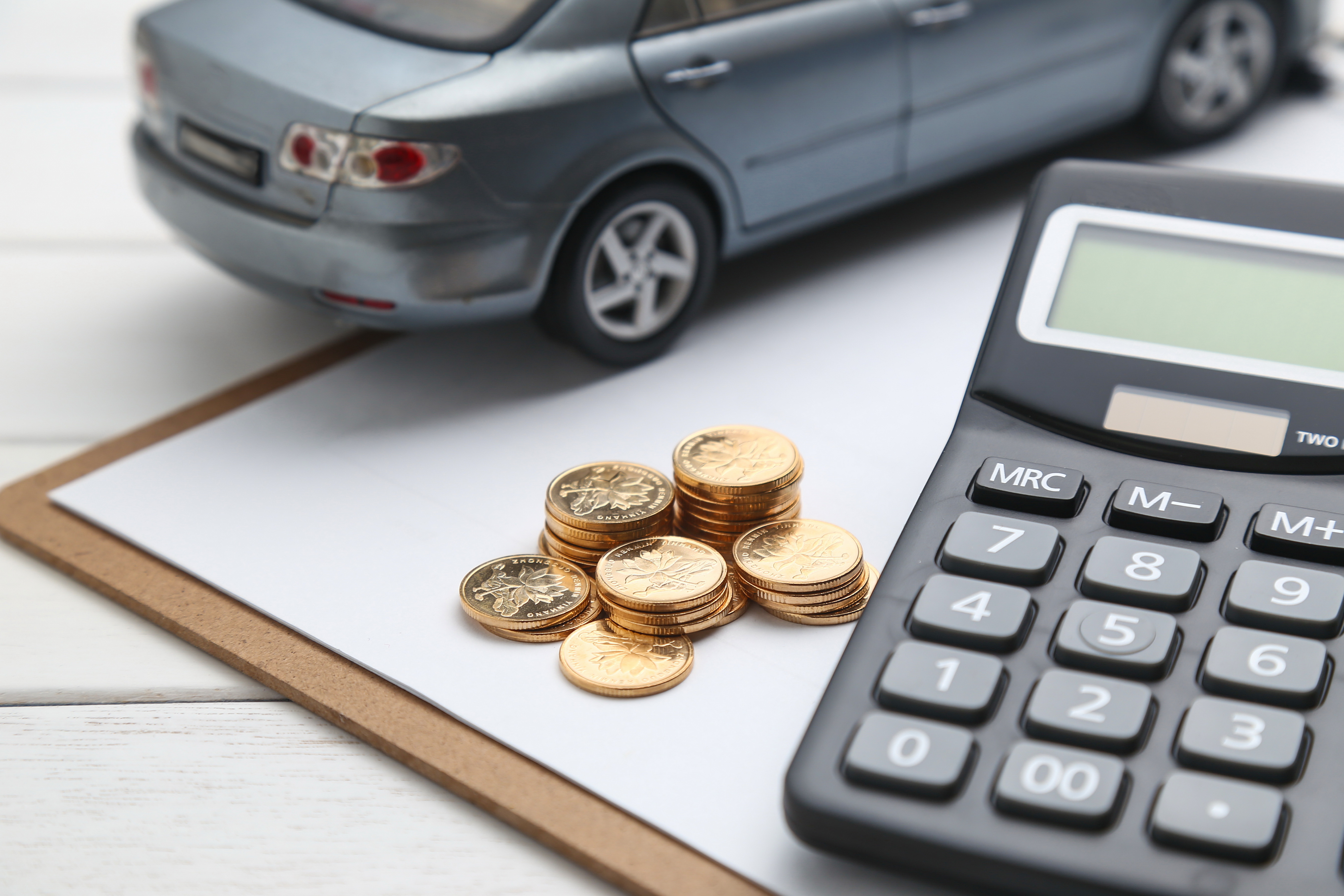 car-model-calculator-coins-white-table(1).jpg