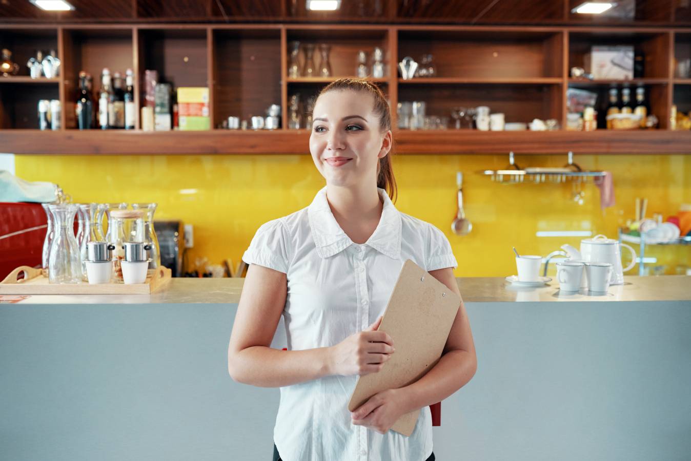 content-woman-with-clipboard-managing-coffee-shop-business.jpg