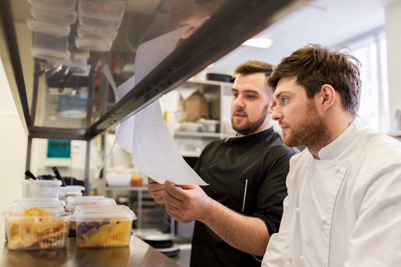 cooking-food-profession-people-concept-happy-male-chef-cook-with-grocery-lists-bills-restaurant-kitchen.jpg