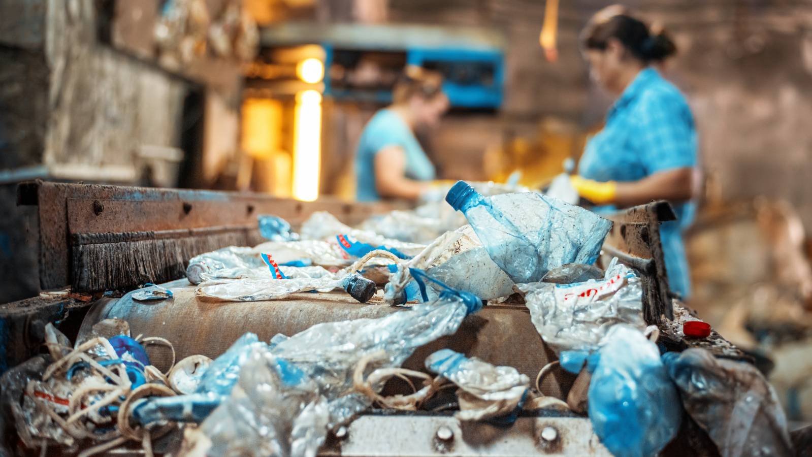 plastic-garbage-conveyor-belt-waste-recycling-factory-workers-background.jpg
