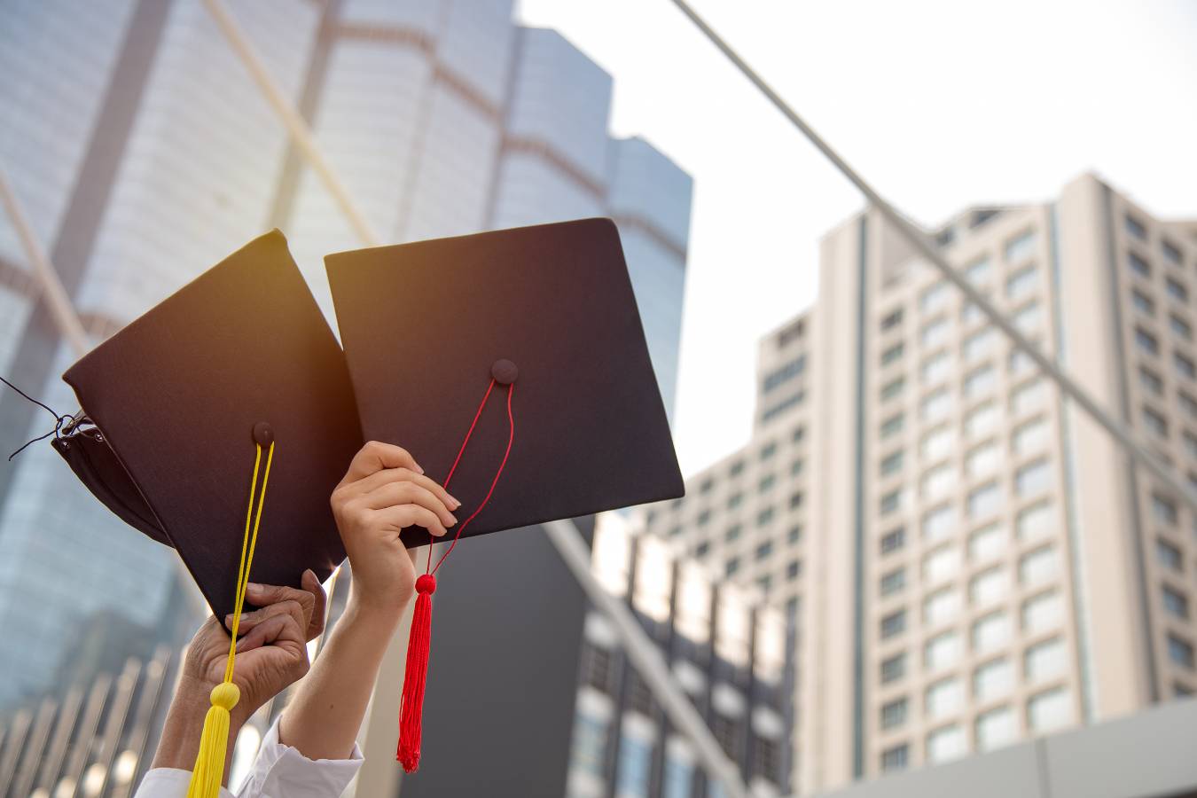 put-hand-holding-graduation-cap-up-sky-with-happiness-graduation-day.jpg